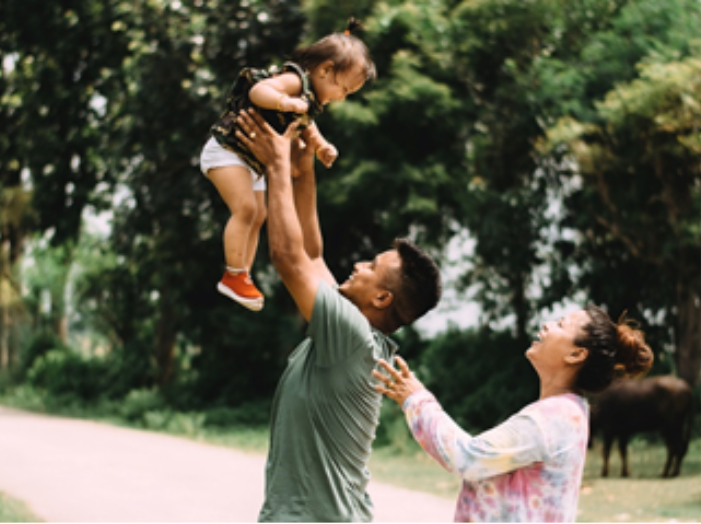 dad holding up baby