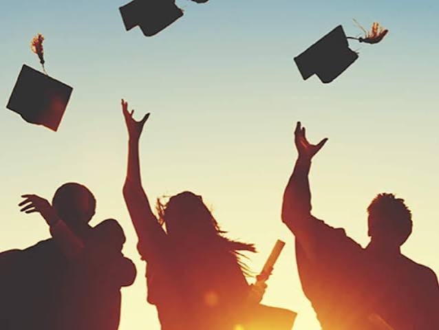 people throwing graduation cap