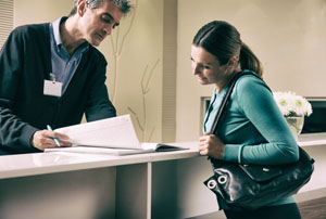 Medical Staff with Patient Going Over Paperwork